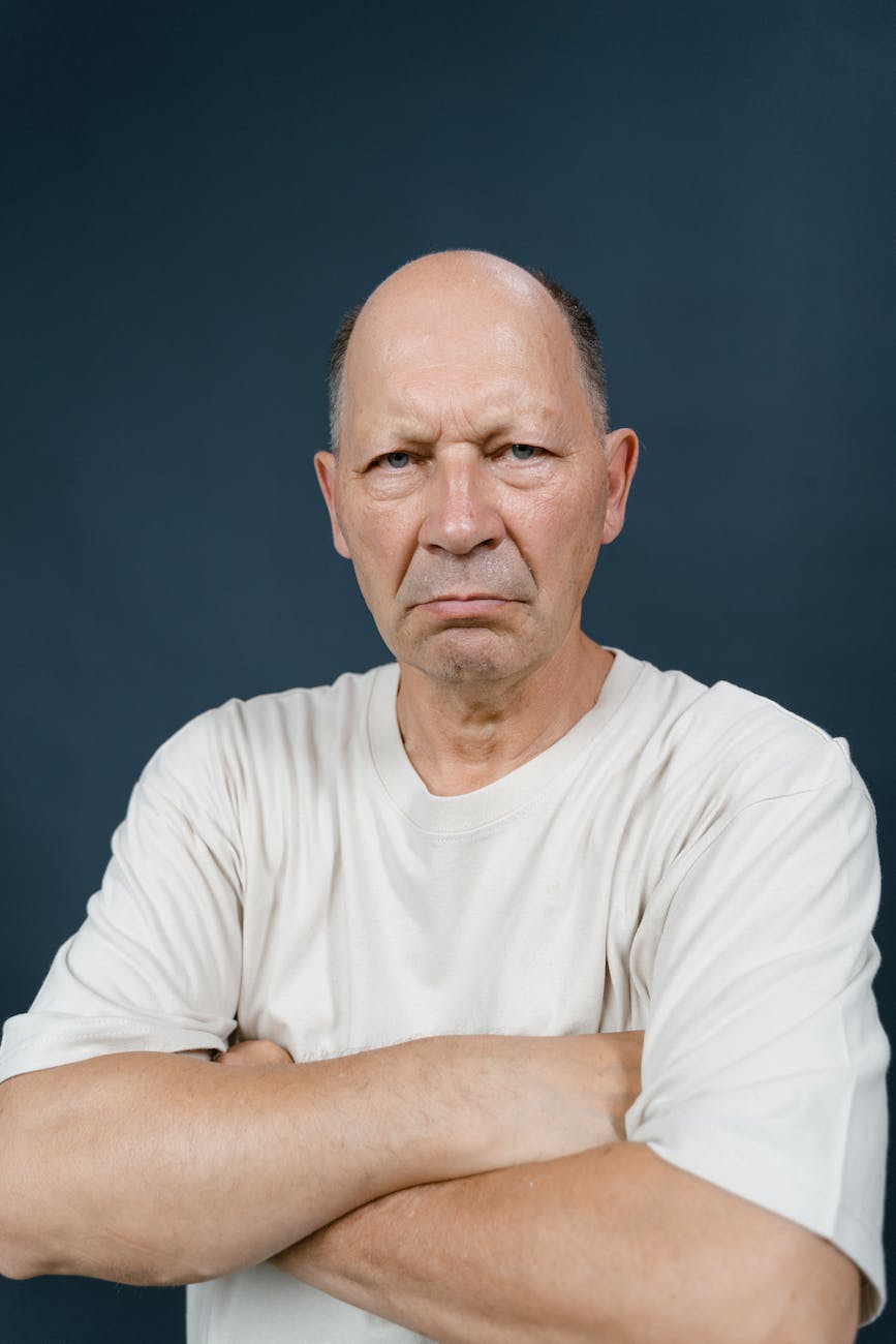 an elderly man with an angry facial expression